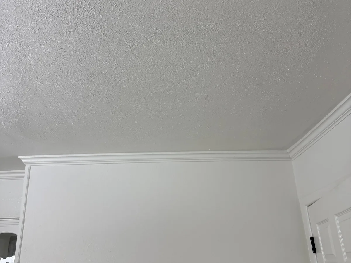Interior corner with freshly painted walls, ceiling and crown molding